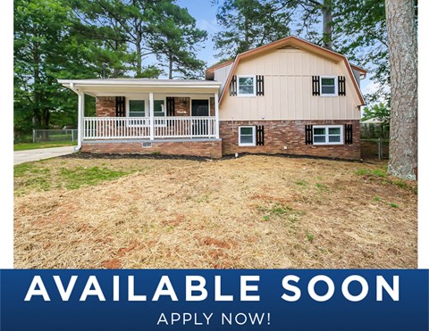 a home with a yard and a white porch and a possible attic